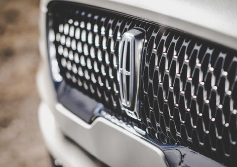 The grille of the 2024 Lincoln Aviator® Reserve model with an eye-catching repeated field of Lincoln Star logo shapes | Mathews Lincoln in Marion OH