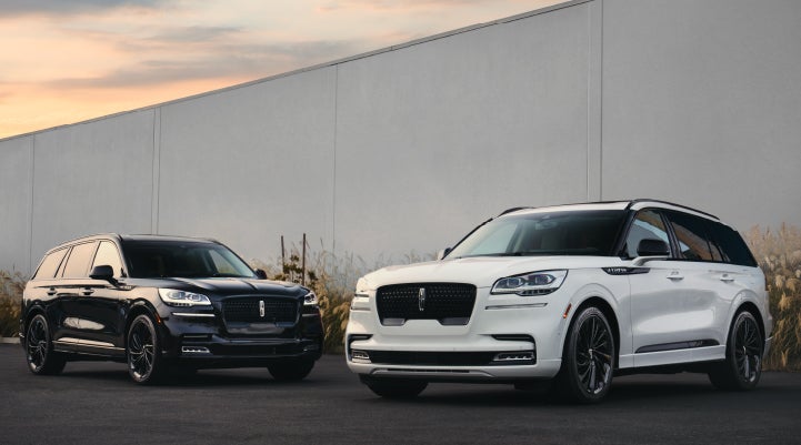 Two Lincoln Aviator® SUVs are shown with the available Jet Appearance Package | Mathews Lincoln in Marion OH
