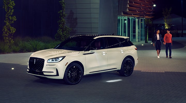 Two people approach a 2024 Lincoln Corsair® SUV featuring the available Jet Appearance Package. | Mathews Lincoln in Marion OH