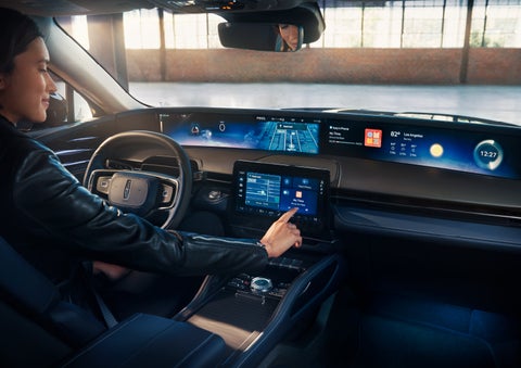 The driver of a 2024 Lincoln Nautilus® SUV interacts with the center touchscreen. | Mathews Lincoln in Marion OH