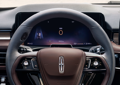The steering wheel of 2025 Lincoln Aviator® SUV is shown with black and brown accents. | Mathews Lincoln in Marion OH