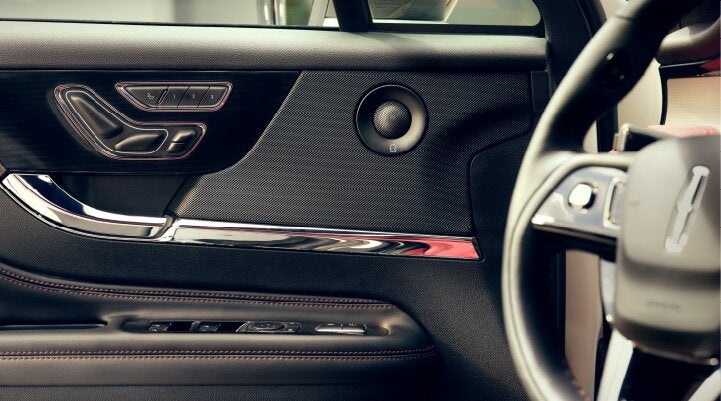 A Revel® audio speaker is shown in the driver's side door of a 2025 Lincoln Corsair® SUV. | Mathews Lincoln in Marion OH