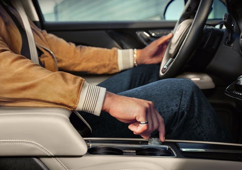 The driver of a 2024 Lincoln Corsair® SUV is shown selecting the drive mode. | Mathews Lincoln in Marion OH