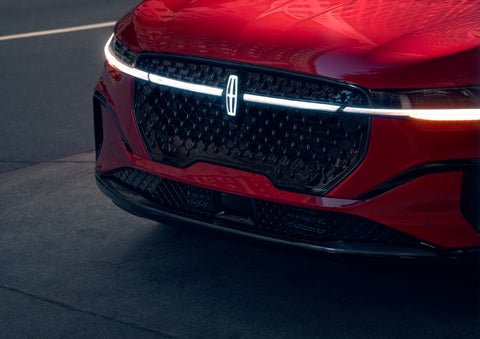 The available front LED light bar and center Lincoln Star logo glow at dusk. | Mathews Lincoln in Marion OH