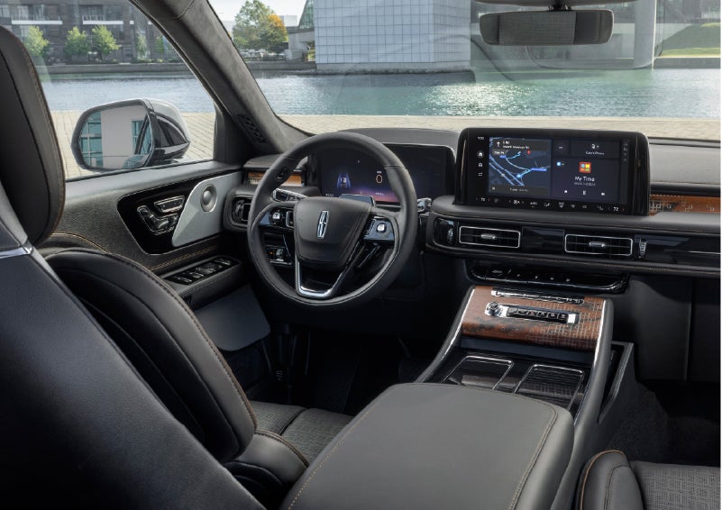 The interior of the 2026 Lincoln Aviator® SUV is shown parked with a view of a harbor through the windshield. | Mathews Lincoln in Marion OH