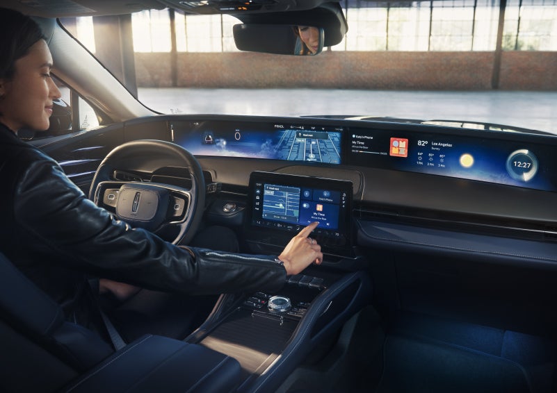 The driver of a 2026 Lincoln Nautilus® SUV interacts with the center touchscreen. | Mathews Lincoln in Marion OH
